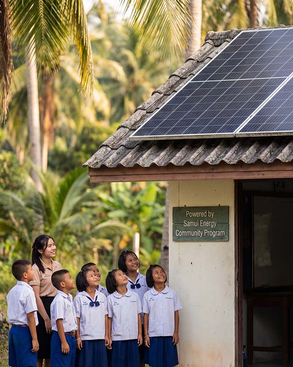 Thai school children with solar panel - Samui Energy Community Program